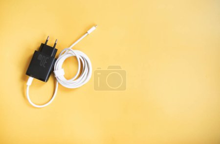 Photo for Electric plug with white cable on yellow background - Royalty Free Image