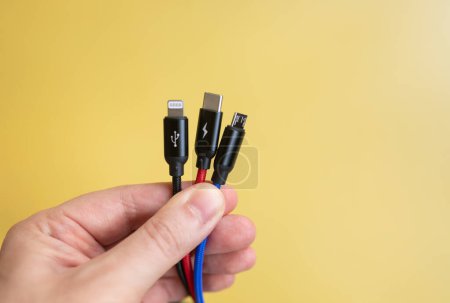 Photo for Electric cables with wires and hand on yellow background. - Royalty Free Image
