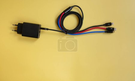 Photo for Electric power supplies and cables on yellow background - Royalty Free Image
