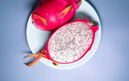 Photo for Close-up view of dragon fruit, exotic dragon fruit on blue background. Pitahaya. - Royalty Free Image