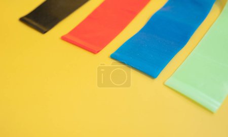 Photo for Set of bright multi-colored rubber bands for fitness on yellow background. Sports concept. Fitness trend. - Royalty Free Image