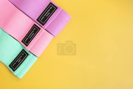 Photo for Set of colourful hip resistance bands for fitness on yellow background. sports concept. - Royalty Free Image