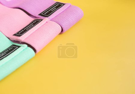 Photo for Set of colourful hip resistance bands for fitness on yellow background. sports concept. - Royalty Free Image
