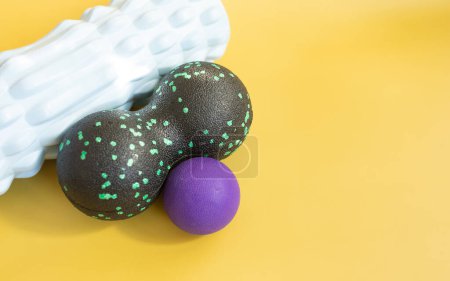 Photo for Fascia rolls and spiky massage balls on yellow background. - Royalty Free Image