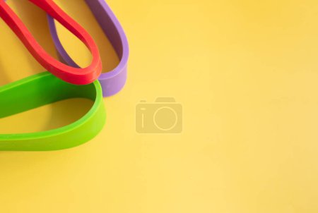 Photo for Set of colourful rubber bands for fitness on yellow background. sports concept. - Royalty Free Image