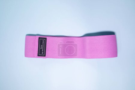Photo for Top view of pink rubber band for fitness on blue background. Sports concept. Fitness trend. - Royalty Free Image