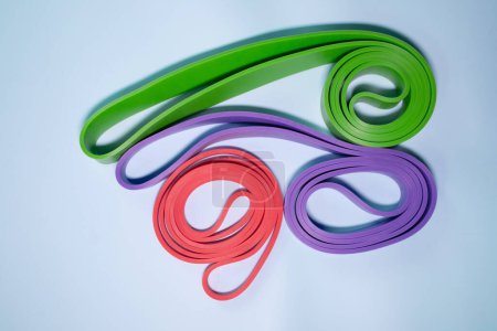 Photo for Set of colourful rubber bands for fitness on blue background. sports concept. - Royalty Free Image