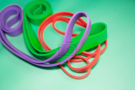 Photo for Set of colourful rubber bands for fitness on green background. sports concept. - Royalty Free Image