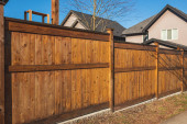Nice wooden fence around house. Wooden fence with green lawn. Street photo, nobody, selective focus Mouse Pad 637764968