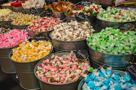 Foto de Cubos llenos de caramelos caramelos en una tienda de dulces. Una variedad de dulces en una tienda. Nadie, enfoque selectivo, borroso - Imagen libre de derechos