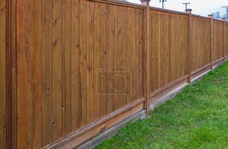 Photo for Nice new white wooden fence around house. Wooden fence with green lawn. Street photo, nobody, selective focus - Royalty Free Image