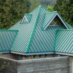 Beautiful green roof with dormer. Decorative metal roof. Types of roof roofs.The roof of the house from a metal profile. Roofing. Stainless steel cladding. Nobody, copyspace for text