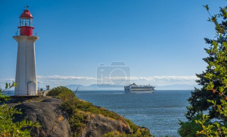 Photo for Cruise ship leaving port of Vancouver BC. The view of a lighthouse and cruise liner in the ocean. Scenic travel background and cruise ship. Travel photo, copyspace for text - Royalty Free Image