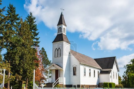 Photo for Church in rural British Columbia Canada. An old country church on a sunny day with blue sky at the background. Exterior of a White Traditional Church in North America-Nobody, travel photo, copy space - Royalty Free Image