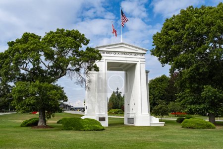 The gate monument in Peace Arch Park, Blaine, Washington, USA. Two countries flags on the monument in Peace Arch Park. USA Canada border. Historical landmark in Surrey, BC-August 30, 2023