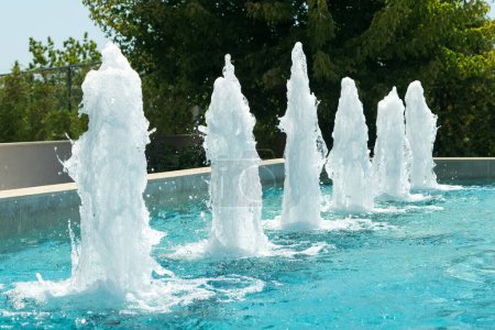 View of a fountain with blue water on a summer day