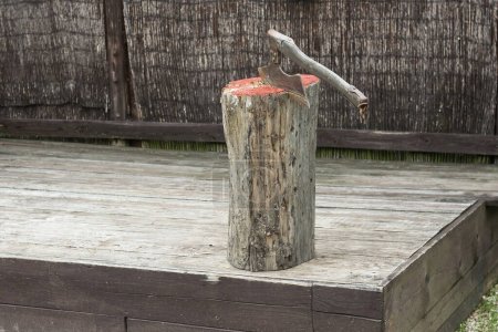 Photo for View of a medieval executioner ax in a wooden stump - Royalty Free Image