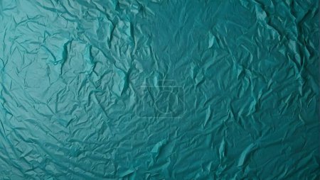 turquoise rough background, tissue paper with space for an inscription