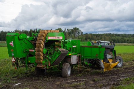 Photo for Matku, Finland - August 21 2021: Mechanical harvester of potatoes intended for human food on a field on a cloudy summer day. - Royalty Free Image