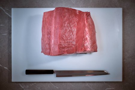 Photo for Shot of uncooked fresh red tuna piece on kitchen table - Royalty Free Image