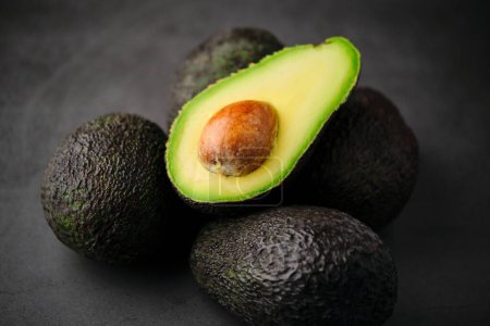 Photo for Stock photo of fresh green organic avocados isolated on black background. - Royalty Free Image
