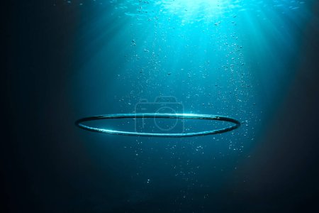 Photo for Underwater shot of big air bubble ring in deep transparent sea with shiny light during summer day - Royalty Free Image