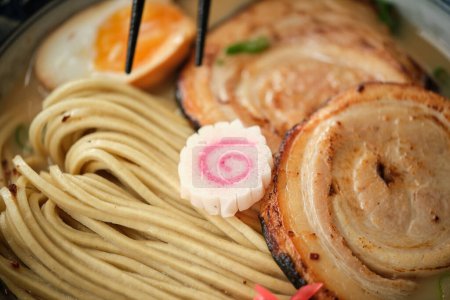 Photo for Closeup of narutomaki in tasty Japanese ramen soup with noodles meat and boiled egg in bowl - Royalty Free Image