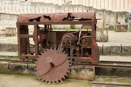 Photo for Old iron machine on rails with gears for heavy mechanical industry work historical monument in Spain - Royalty Free Image