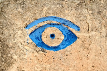 Photo for Closeup of blue eye painted on wall at sandstone quarry, Lithica, Pedreres de S Hostal, Menorca, Balearic Islands - Royalty Free Image