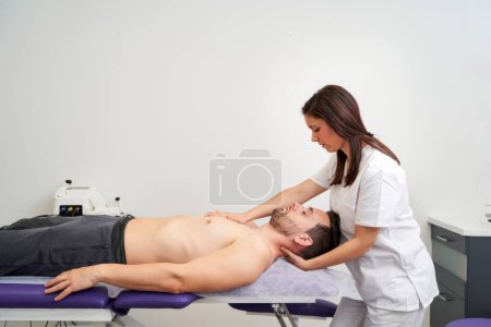 Photo for A man being treated for a spinal cord injury at the physiotherapist's office - Royalty Free Image