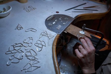 Foto de Desde arriba de la cosecha orfebre anónimo poner joyas en finagel mientras se trabaja en el taller - Imagen libre de derechos