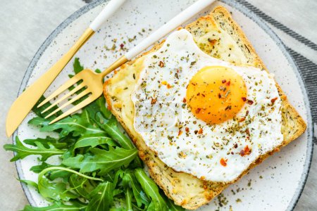 Photo for Delicious breakfast of fried eggs with toast and salad. - Royalty Free Image