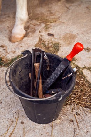 Photo for Bucket with tools of blacksmith of horses - Royalty Free Image