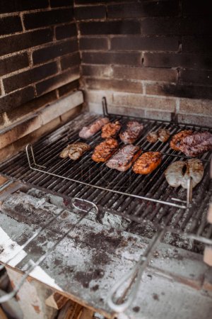 Photo for Cooking sausages and chorizo in barbecue - Royalty Free Image