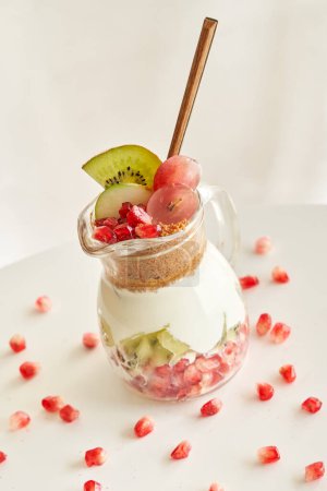 Photo for Delicious yogurt dessert with pomegranate, kiwi, grape and ginger biscuit - Royalty Free Image