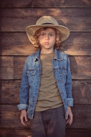Photo for Happy kid about village style spending time looking at camera in bright light - Royalty Free Image
