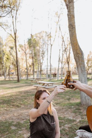 Photo for Young musicians drinking beer in park - Royalty Free Image