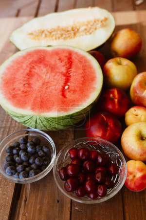 Photo for Delicious summer fruits on wooden table - Royalty Free Image