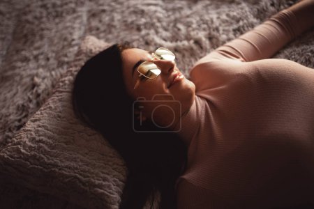 Photo for Young woman lying on bed - Royalty Free Image