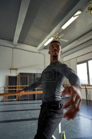 Photo for Boy black dancer in a warm-up and dancing in a ballet class - Royalty Free Image