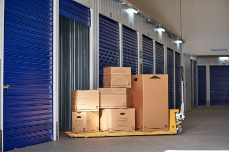 Photo for Storage in an industrial building for rental to entrepreneurs or individuals with recyclable cardboard boxes on top of a pallet rack - Royalty Free Image