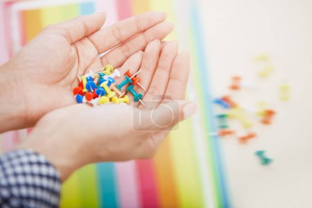 Photo for Woman hands with colorful pushpins - Royalty Free Image