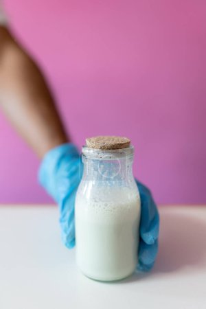 Photo for Close up of a worker grabbing a milk jar for making rolled ice cream. Concept of new small business - Royalty Free Image
