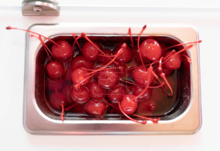 Photo for Close up photo of a metal tray filled with cherry toppings on an ice cream parlor counter. Concept of small business - Royalty Free Image