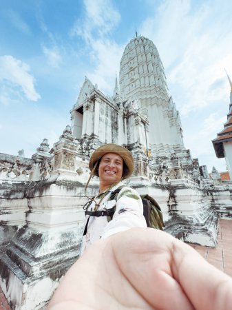 cheerful traveler captures a moment at a white stupa, Stupa Selfie with Beaming Traveler.