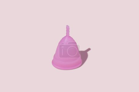 Photo for Pink reusable silicone menstrual cup on pink background. Concept of feminine hygiene, gynecology and health - Royalty Free Image