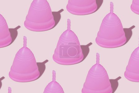 Photo for Pink reusable silicone menstrual cups on pink background. Concept of feminine hygiene, gynecology and health. Pattern - Royalty Free Image