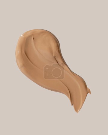 Makeup foundation, beige concealer swatch smudge smear on beige background. BB CC cream texture