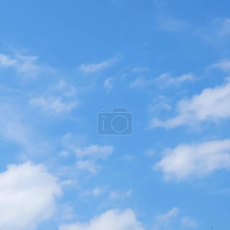 Photo for Cumulus clouds dance high in the vast sky, their fluffy shapes creating a picturesque spectacle against the azure backdrop. The whims of nature are reflected in the ever-changing shapes and soft edges of these clouds - Royalty Free Image