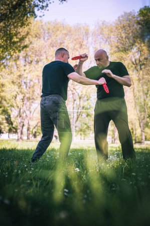 Photo for Knife vs knife fight combat training. Sumbrada training method. Plastic weapon defend demonstration drill - Royalty Free Image